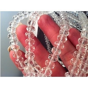 Glass Beads 4mm Crystal Clear BD400 closeup with hand