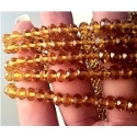 Glass Beads 6mm Faceted Amber bd606 closeup image with hand